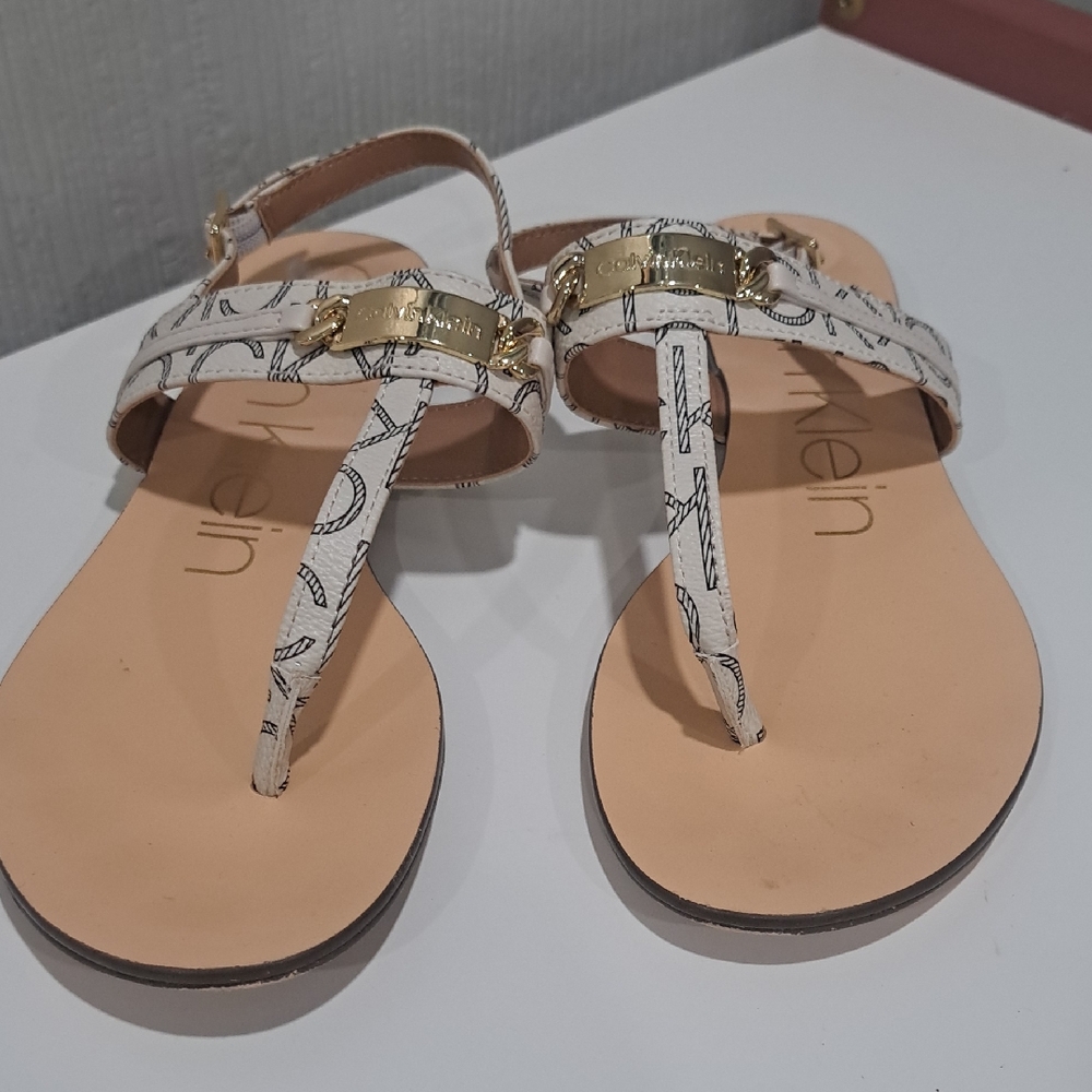 Calvin Klein Soley Sandals - Cream and Gold With Black Lettering.